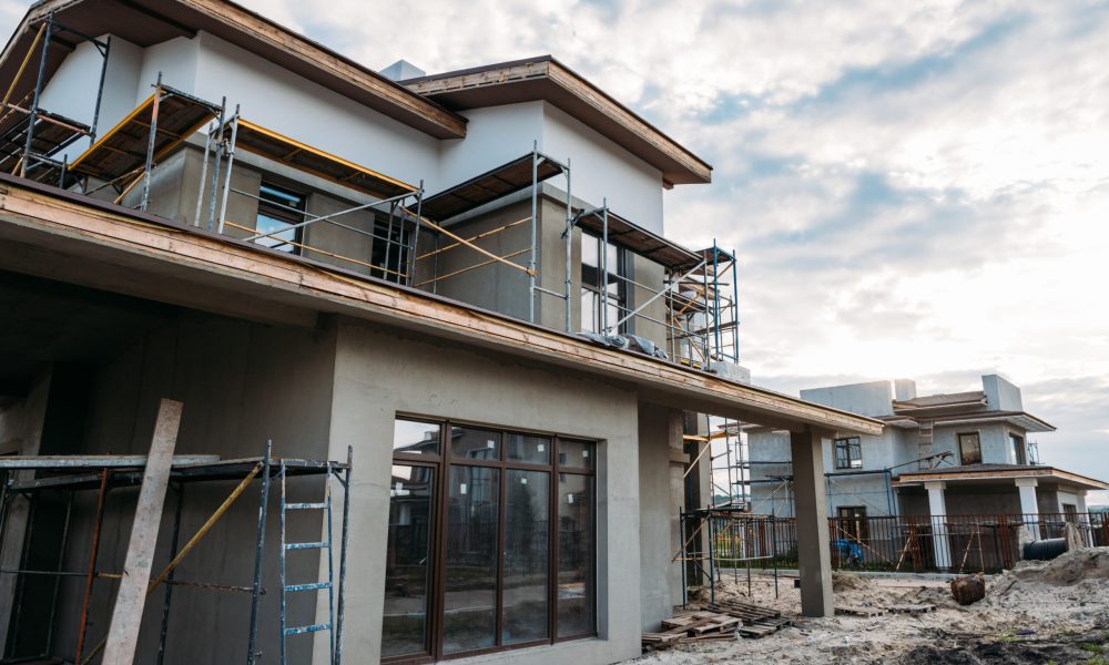 close-up shot of contemporary building construction with scaffolding under cloudy sky